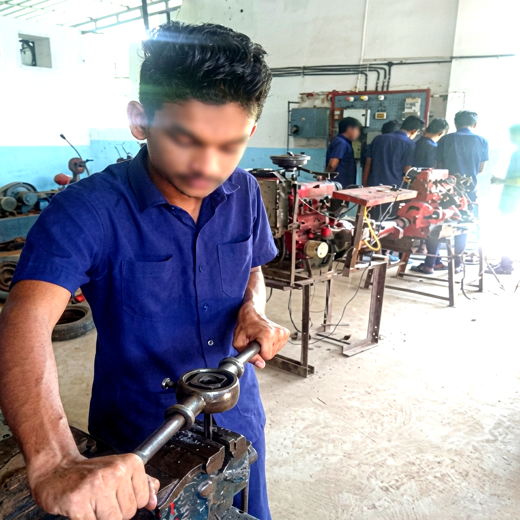 Student practicing with workshop tools on an automobile